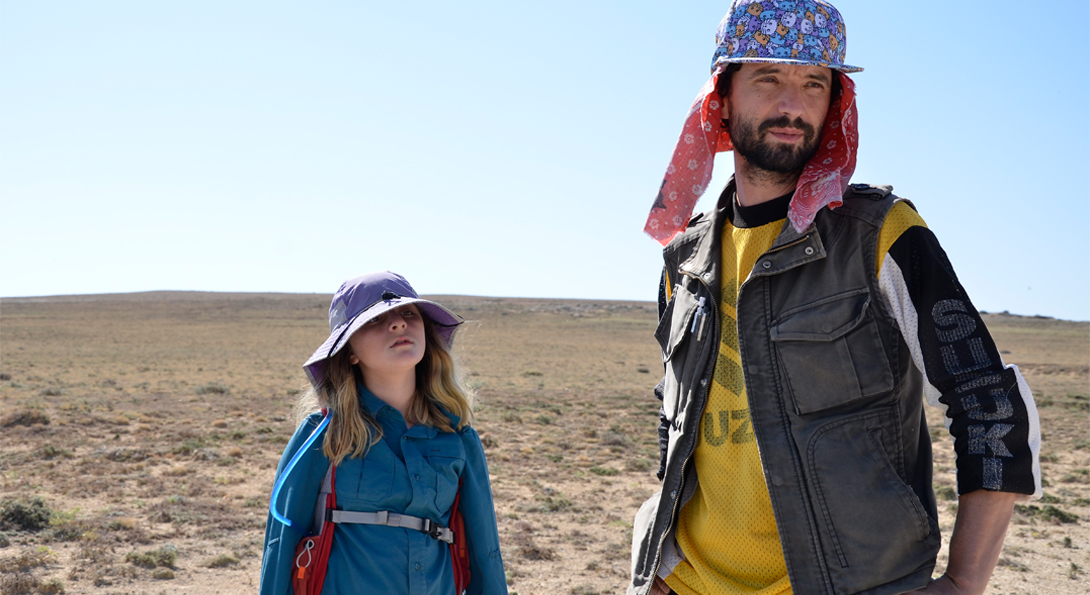 A photograph of two people standing in an empty